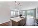 Modern kitchen with gray cabinets, island, and stainless steel appliances at 14917 Tamarack Dr, Charlotte, NC 28278