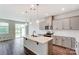 Modern kitchen with gray cabinets, island, and stainless steel appliances at 14917 Tamarack Dr, Charlotte, NC 28278