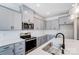 Modern kitchen features gray cabinets, quartz countertops, and stainless steel appliances at 14917 Tamarack Dr, Charlotte, NC 28278