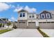Two-story townhome with two-car garage and stone accents at 14917 Tamarack Dr, Charlotte, NC 28278