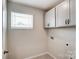 Laundry room with upper cabinets and hookups at 14917 Tamarack Dr, Charlotte, NC 28278