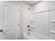 Clean bathroom with a bathtub, shower, and built-in shelves at 14917 Tamarack Dr, Charlotte, NC 28278
