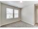 Bright bedroom with grey carpet and two windows with blinds at 14917 Tamarack Dr, Charlotte, NC 28278