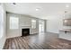 Living area with hardwood floors, fireplace, and access to patio at 14917 Tamarack Dr, Charlotte, NC 28278