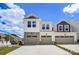Two-story townhome with two-car garage and stone accents at 14917 Tamarack Dr, Charlotte, NC 28278