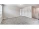 Upstairs bedroom with neutral carpeting and double door closet at 14917 Tamarack Dr, Charlotte, NC 28278