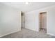 Bedroom with grey carpet, access to closet, and hallway at 14917 Tamarack Dr, Charlotte, NC 28278