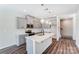 Modern kitchen with gray cabinets, island, and stainless steel appliances at 14917 Tamarack Dr, Charlotte, NC 28278