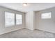 Spacious bedroom with neutral walls and carpet, plus two windows at 14917 Tamarack Dr, Charlotte, NC 28278