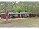 Brick ranch house with a landscaped yard at 4909 Pleasant Grove Rd, Waxhaw, NC 28173