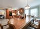 Kitchen and dining area with wood cabinets and tiled floor at 4909 Pleasant Grove Rd, Waxhaw, NC 28173