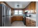 Kitchen with wood cabinets, stainless steel appliances, and tile floors at 24947 Nc 24/27 Hwy, Albemarle, NC 28001