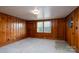 Cozy living room featuring knotty pine walls and built-in shelving at 24947 Nc 24/27 Hwy, Albemarle, NC 28001