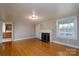 Hardwood floors, fireplace, view into kitchen with wood cabinets at 24947 Nc 24/27 Hwy, Albemarle, NC 28001