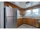 Stainless steel refrigerator and wood cabinets in kitchen at 24947 Nc 24/27 Hwy, Albemarle, NC 28001