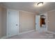 Simple bedroom with carpet, a closet, and access to another room at 24947 Nc 24/27 Hwy, Albemarle, NC 28001