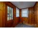 Laundry area with wood paneling, window, and exterior access at 24947 Nc 24/27 Hwy, Albemarle, NC 28001