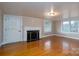 Living room with hardwood floors, fireplace, and built-in shelving at 24947 Nc 24/27 Hwy, Albemarle, NC 28001