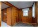 Small bathroom with wood paneling and a window at 24947 Nc 24/27 Hwy, Albemarle, NC 28001