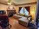 Living room with corner fireplace and L-shaped sofa at 1668 Lane Rd, Mount Holly, NC 28120