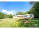 Single-wide mobile home on a spacious lot with a large yard at 1668 Lane Rd, Mount Holly, NC 28120