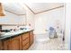 Bathroom with double vanity, soaking tub, and toilet at 1668 Lane Rd, Mount Holly, NC 28120