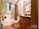 Full bathroom with tub/shower combo and wood vanity at 1668 Lane Rd, Mount Holly, NC 28120