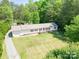 Single-story home with attached garage and large yard at 1668 Lane Rd, Mount Holly, NC 28120