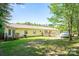 Back of house with deck, ramp, and large yard space at 1668 Lane Rd, Mount Holly, NC 28120