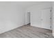 Bright bedroom with gray vinyl flooring and an open door to another room at 253 Artemis Pl, Kershaw, SC 29067