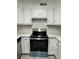 Modern kitchen features stainless steel appliances and white cabinets at 2123 Carriage Woods Ln, Kannapolis, NC 28081