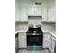 Modern kitchen features stainless steel appliances and white cabinets at 2123 Carriage Woods Ln, Kannapolis, NC 28081