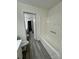 Bathroom with a bathtub and separate toilet area, featuring gray flooring at 2123 Carriage Woods Ln, Kannapolis, NC 28081