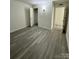 Large bedroom with gray laminate wood flooring and closet at 2123 Carriage Woods Ln, Kannapolis, NC 28081