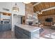 Open concept kitchen and dining area with a large island and brick fireplace at 364 Catalina Dr, Mooresville, NC 28117