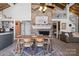 Open dining area with wooden table, brick fireplace, and kitchen view at 364 Catalina Dr, Mooresville, NC 28117