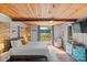 Lake view bedroom with wood ceiling and access to patio at 364 Catalina Dr, Mooresville, NC 28117