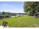 Lakefront backyard with grassy area, dock, and playset at 364 Catalina Dr, Mooresville, NC 28117
