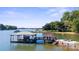 Private lakefront dock with covered boathouse and seating area at 364 Catalina Dr, Mooresville, NC 28117
