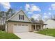 Single-story home featuring a brick and siding facade and a covered porch at 5311 Carden Dr, Charlotte, NC 28227