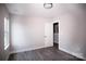 Simple bedroom with light walls, wood-look floors, and a window at 5319 Carden Dr, Charlotte, NC 28227