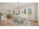 Bright dining room with glass table, modern light fixture, and access to backyard at 607 Julia Ave, Belmont, NC 28012