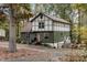 Tudor style home with green siding and pink door at 11901 Ranburne Rd, Mint Hill, NC 28227