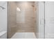 Large shower with glass enclosure and neutral tile at 4018 Capital Ridge Ct, Charlotte, NC 28205