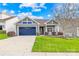 Gray house with blue garage door and landscaped yard at 131 Chimney Rock Ct, Denver, NC 28037