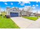 Gray house with blue garage door and landscaped yard at 131 Chimney Rock Ct, Denver, NC 28037