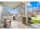 Covered front porch with brick columns and wooden bench at 131 Chimney Rock Ct, Denver, NC 28037