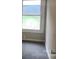 Well-lit bedroom featuring a window and gray carpeting at 605 N Mcfarland N St, Gastonia, NC 28054