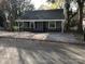 Updated bungalow with gray siding, new front porch and gravel driveway at 605 N Mcfarland N St, Gastonia, NC 28054