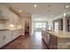 Kitchen island with white cabinets, quartz countertops and stainless steel appliances at 10881 Greenvale Dr, Harrisburg, NC 28075